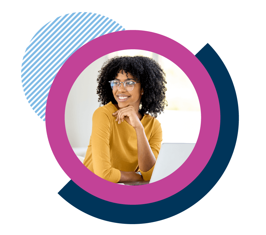 Happy employee wearing glasses at a laptop