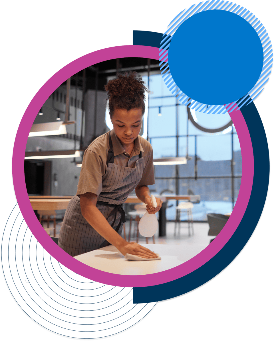 Female hospitality worker cleaning tables