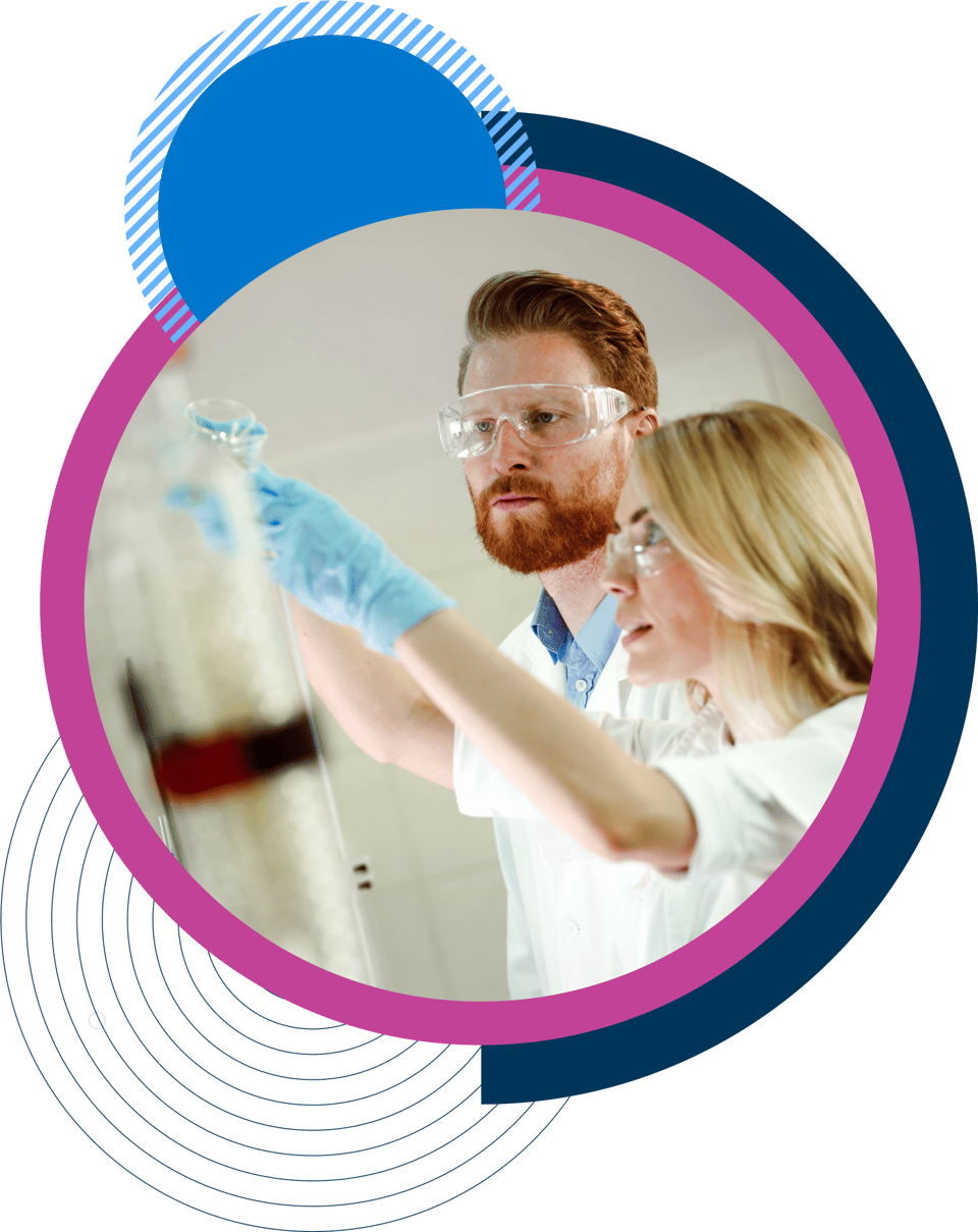 Two scientists in a lab wearing safety goggles