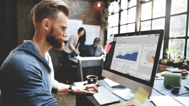 Man looking at screen of Learning Analytics